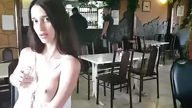 Girl undresses in a bar surrounded by strangers