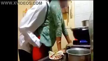 indian new married couple romance in kitchen.