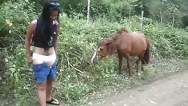 XXX female stops by horses to touch Desi animals and pee in sex video