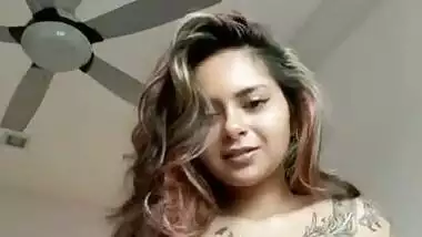 Beautiful tattoed girl showing her boobies