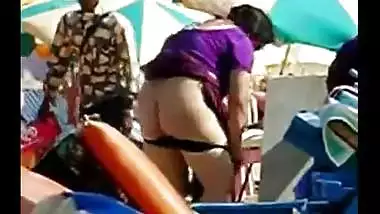 Aunty undresses on foreign beach