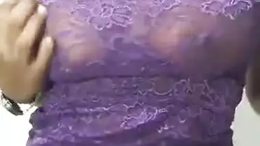 Krisha in violet top pressing her boob and talking