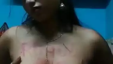 Indian girl with headphones in ears exposes XXX boobies with sex text on